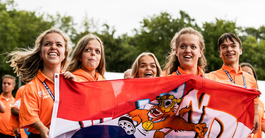 Acht Menschen der niederländischen Nationalmannschaft die Stolz Ihre Nationalflagge präsentieren